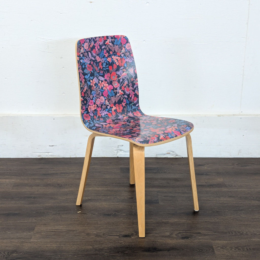 2. Side view of a Reperch dining chair, showing its floral-patterned seat and natural bentwood legs.