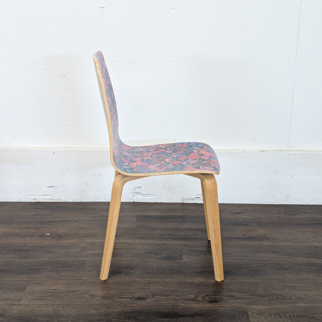 3. Profile view of a Reperch dining chair, featuring a bright floral design on the seat and backrest.