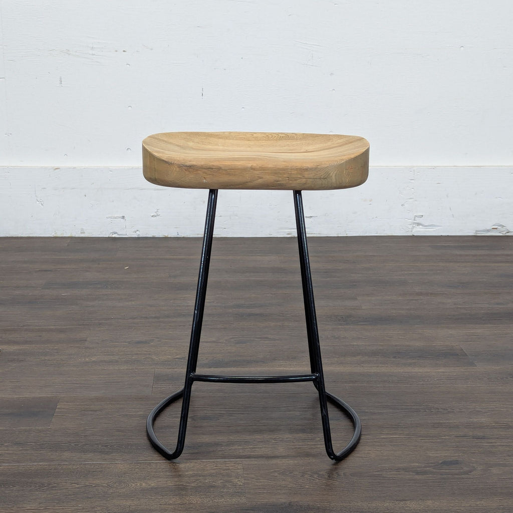 2. Industrial-style stool by Restoration Hardware featuring a thick wood seat and minimalist black metal legs.
