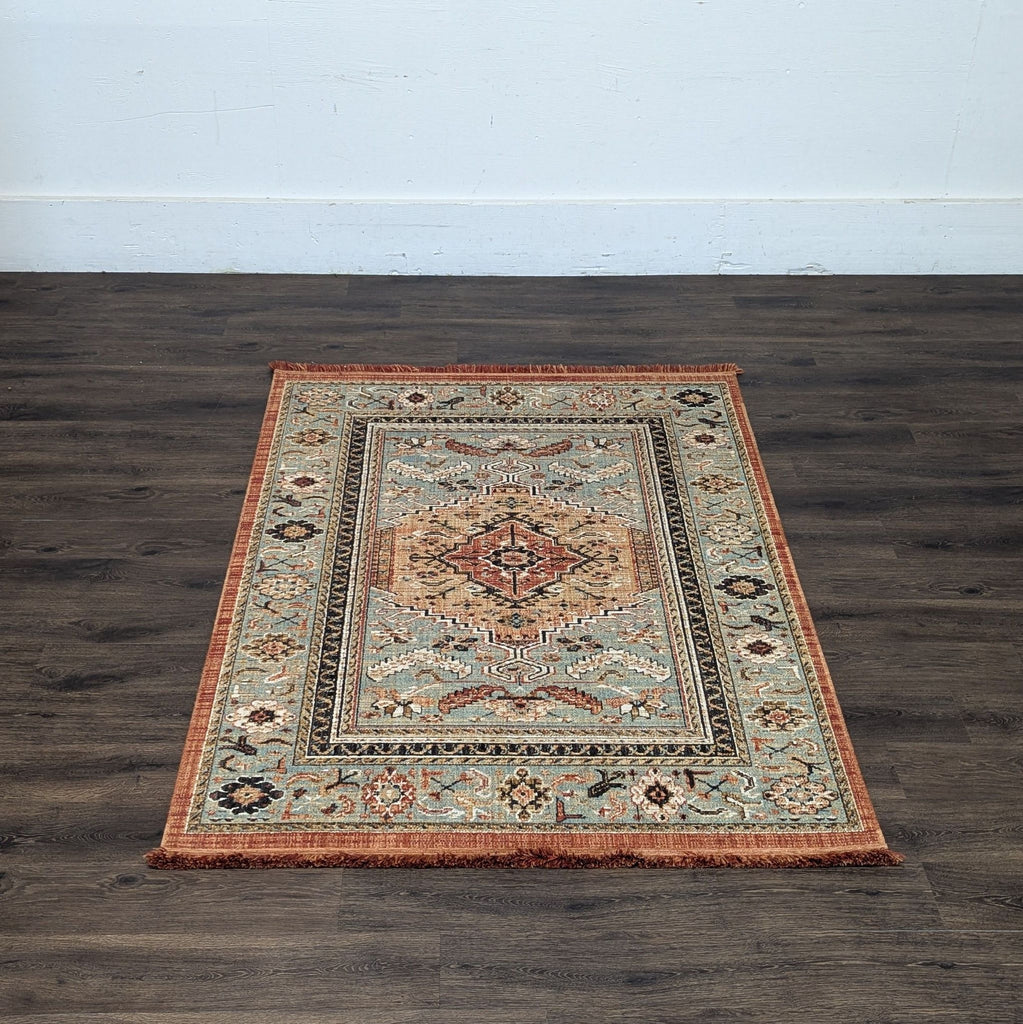 2. Ornate Reperch area rug with a rust border and central medallion, displayed on dark hardwood flooring.