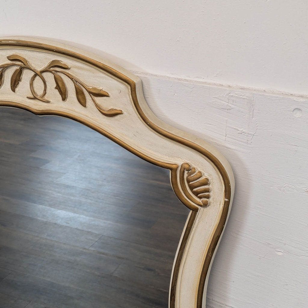 Close-up of the Drexel Heritage mirror's upper frame, highlighting ornate carved details and elegant curves.