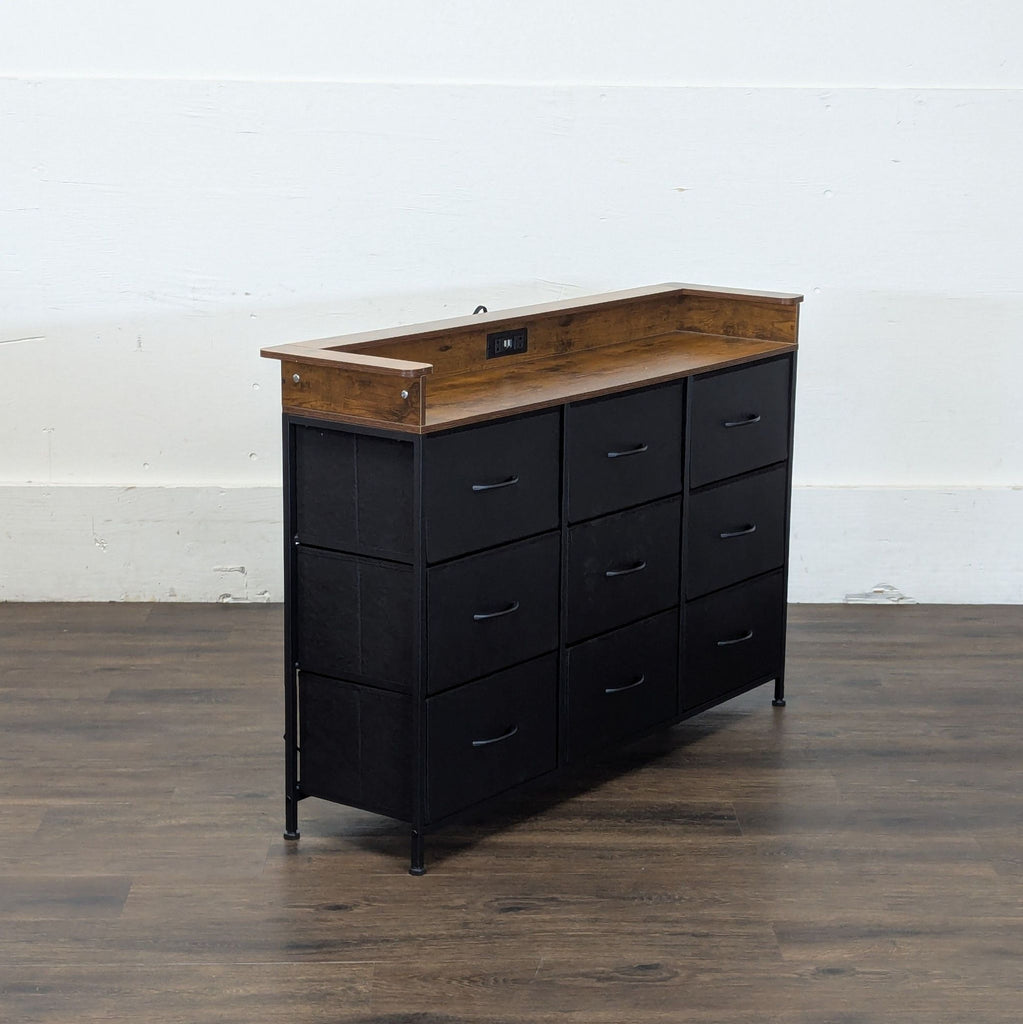 3. Angled side view of a modern cabinet with nine drawers, wood top, and built-in socket, on wooden flooring.