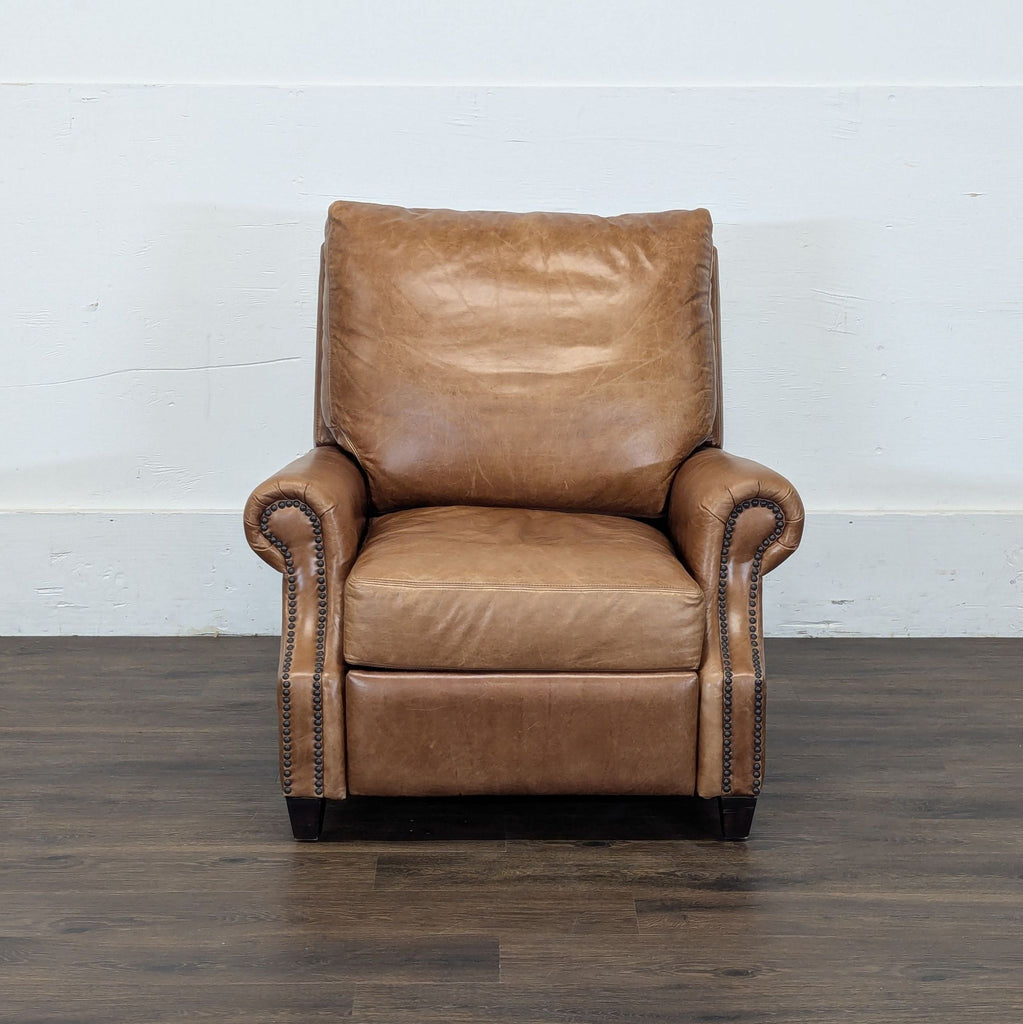 2. Classic Pottery Barn lounge chair in tan leather, featuring rolled arms and antique-style nailhead detailing.  