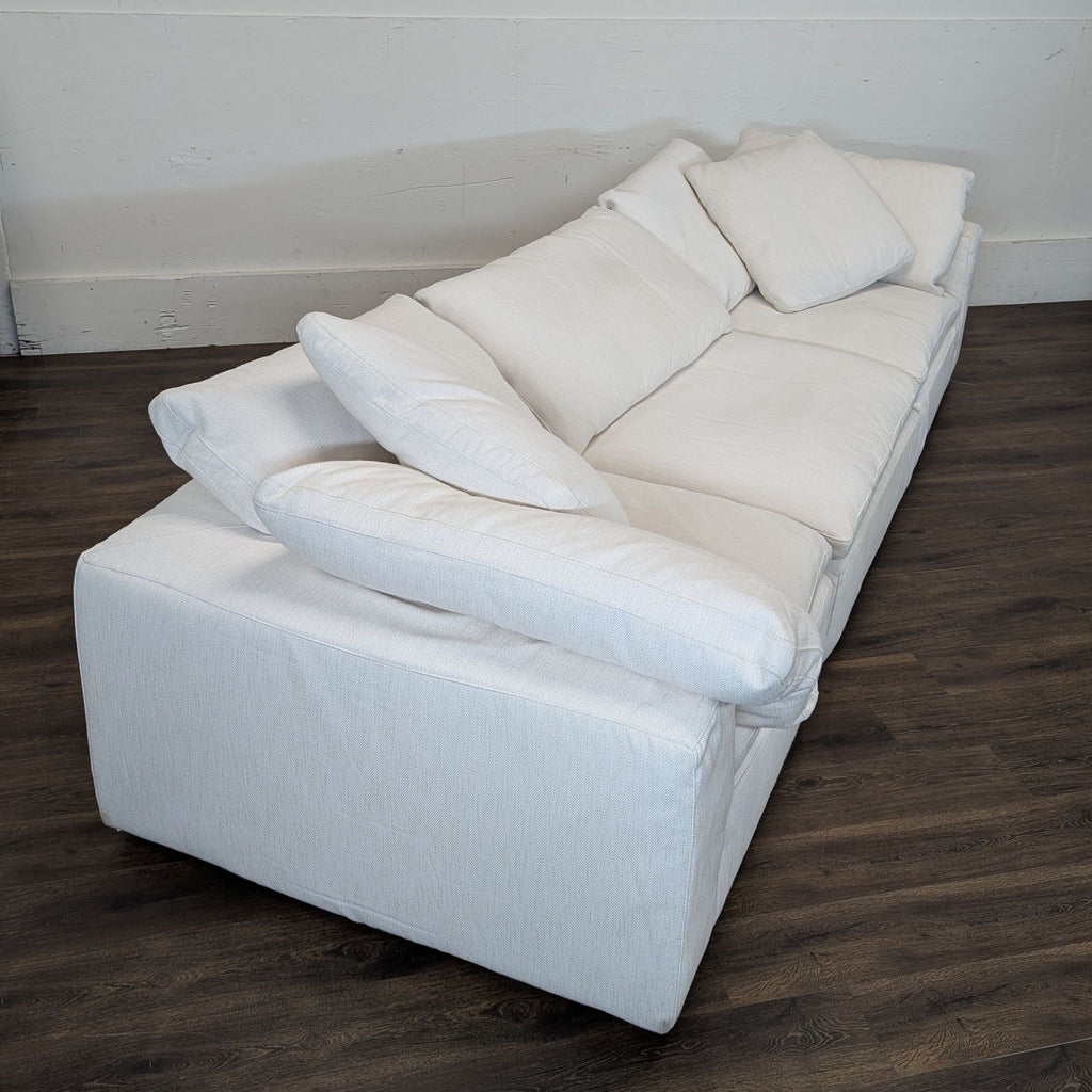 3. Overhead corner view of a Reperch sectional couch in white, emphasizing its deep seats and modern design.