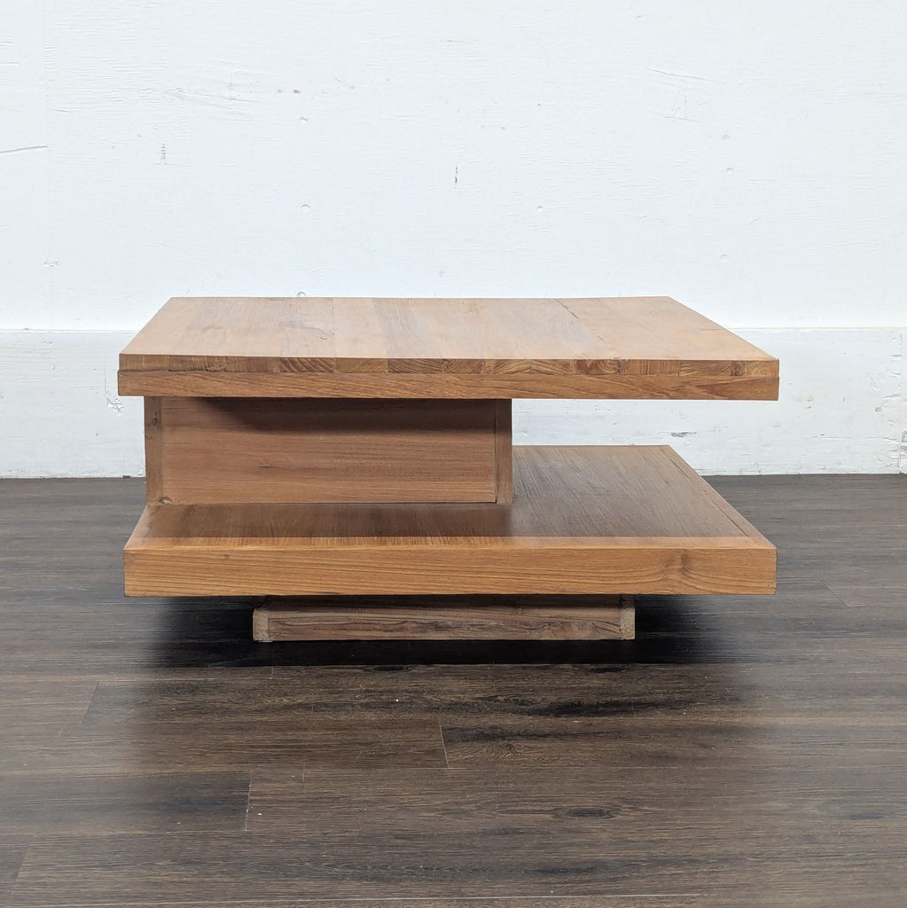 1. Modern Reperch coffee table with layered rectangular wooden design and open shelf, placed on dark wood floor.
