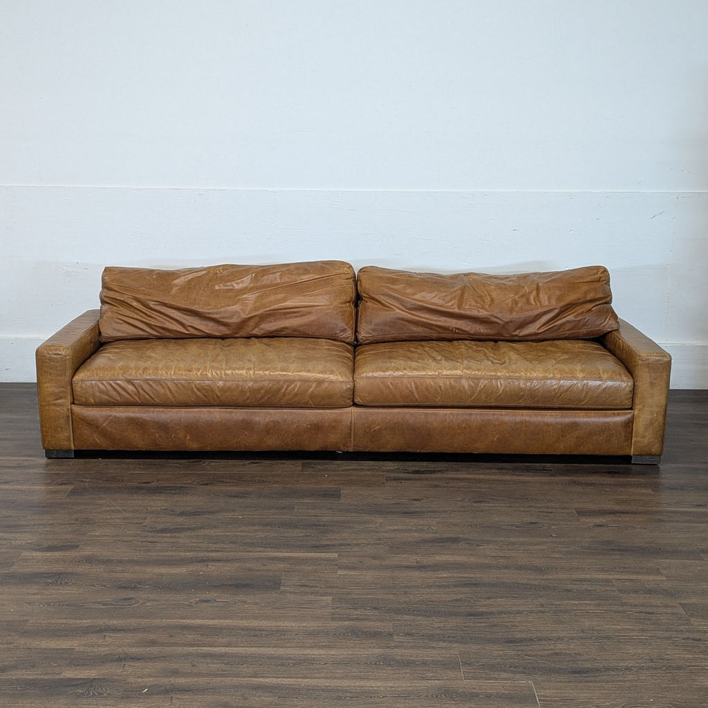 2. Front view of a Maxwell Sofa 3-seat leather couch featuring two back cushions and a worn, vintage appearance.