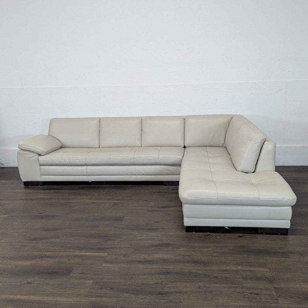 3. Light gray Reperch sectional sectional with plush seating, angled to show its L-shape design on hardwood.