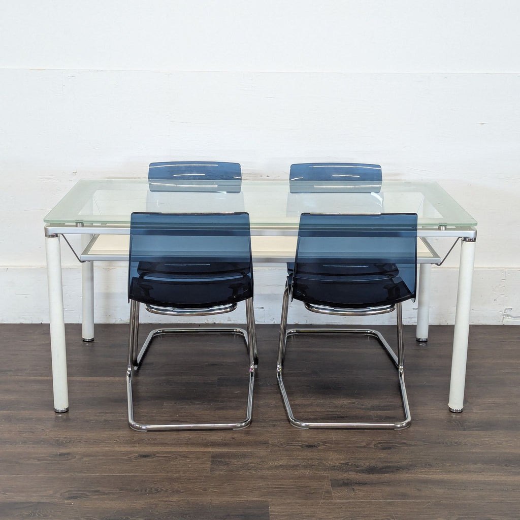 1. Reperch dining set featuring a glass table and four blue modern chairs on a dark wood floor.  