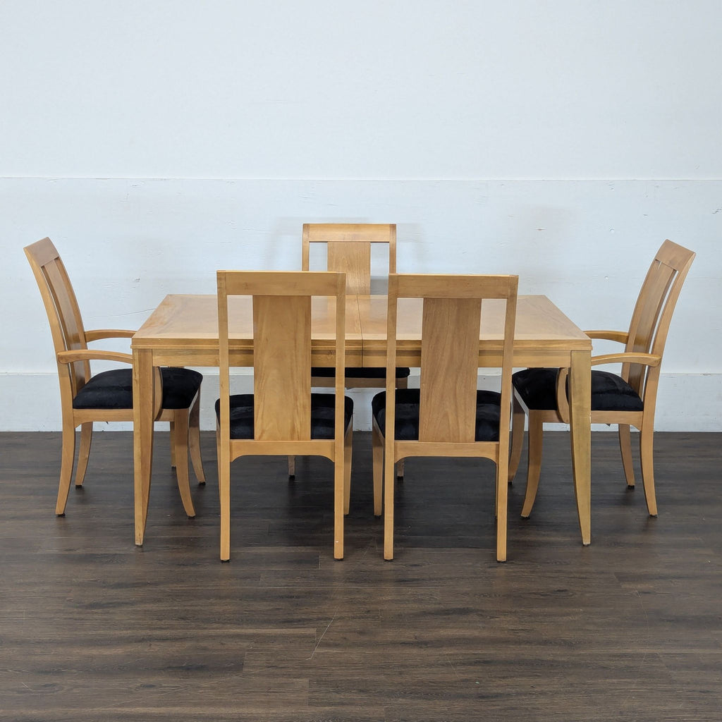 Ethan Allen dining set featuring a rectangular light wood table and six chairs with black seat cushions in a studio.  