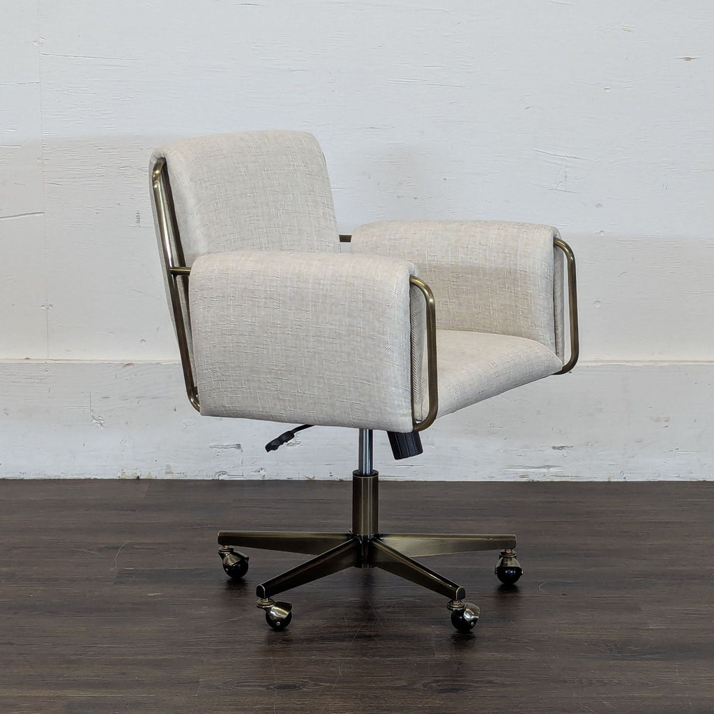 2. Side angle of Crate and Barrel office chair showcasing light fabric, padded arms, and five-wheel metal base.