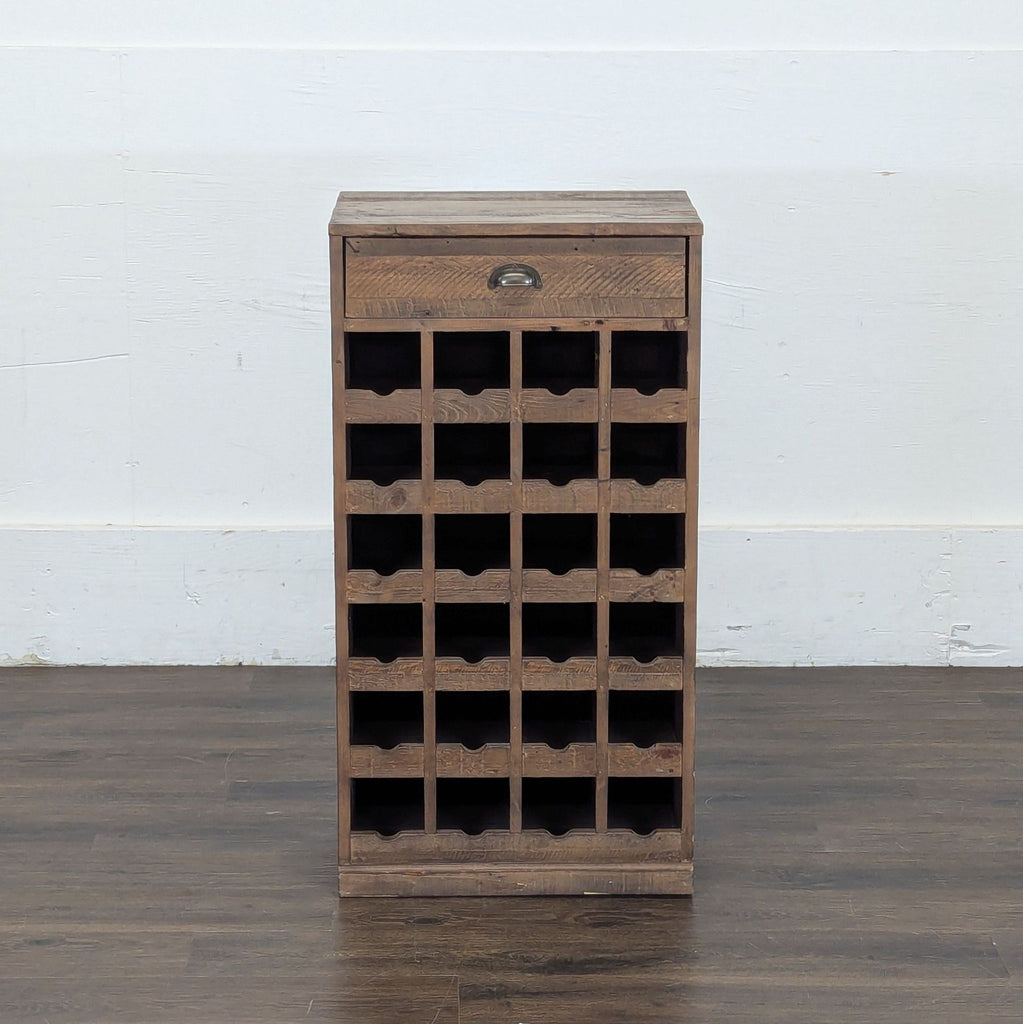 2. Single Pottery Barn rustic wooden wine rack cabinet with a drawer and multiple bottle storage slots, on wood flooring.