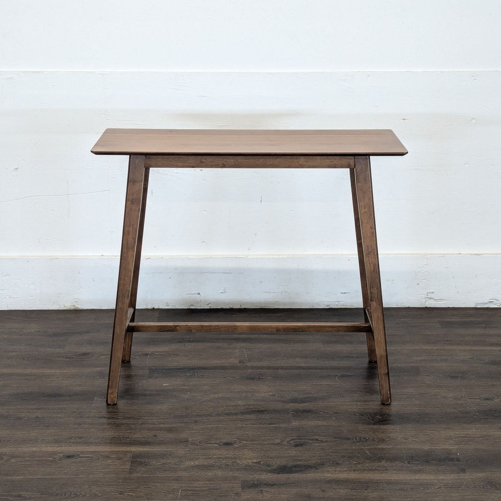 2. Noble House Home rectangular wooden dining table with angled legs, shown on dark wood flooring.