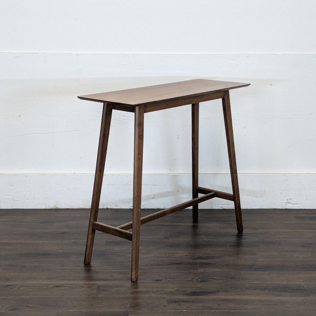3. Side angle of Noble House Home dining table, featuring slim legs and a minimalist wood design.