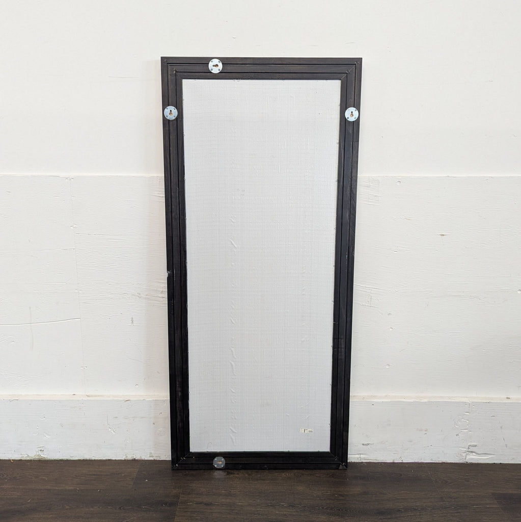 3. Back view of a rectangular Ikea mirror with visible mounting hardware and a dark outer frame.