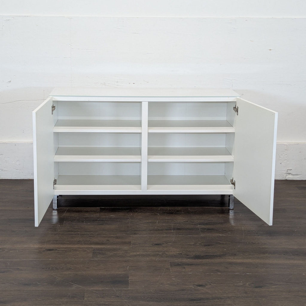 3. Ikea cabinet open to reveal six interior shelves, offering ample organized storage space.
