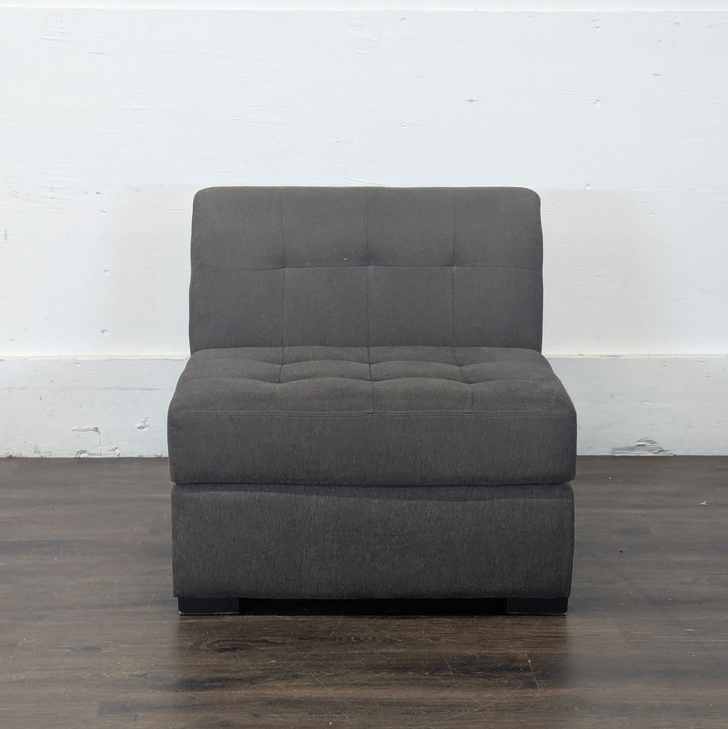 3. Full front view of a Jonathan Louis lounge chair in dark gray upholstery with tufted detailing.
