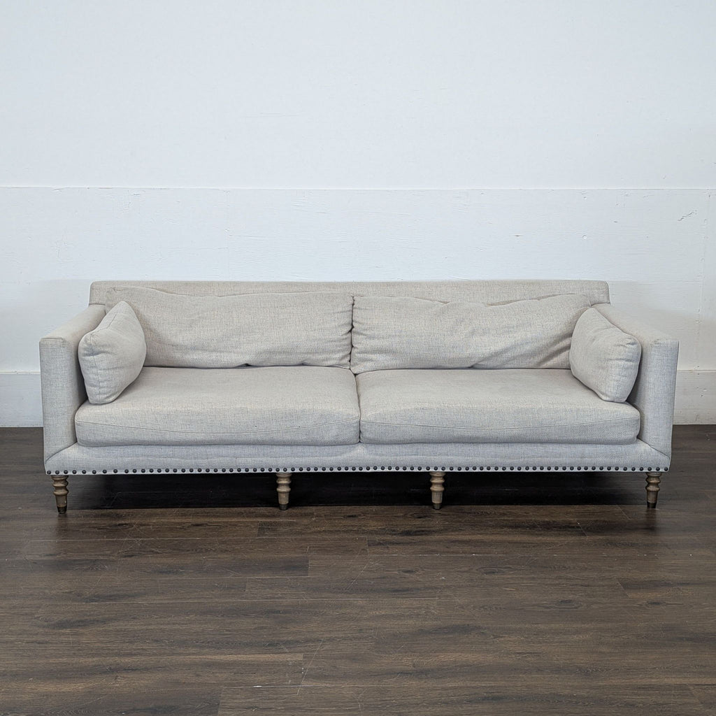 3. Contemporary three-seat Pottery Barn couch in a cozy, inviting style, ideal for family gatherings.