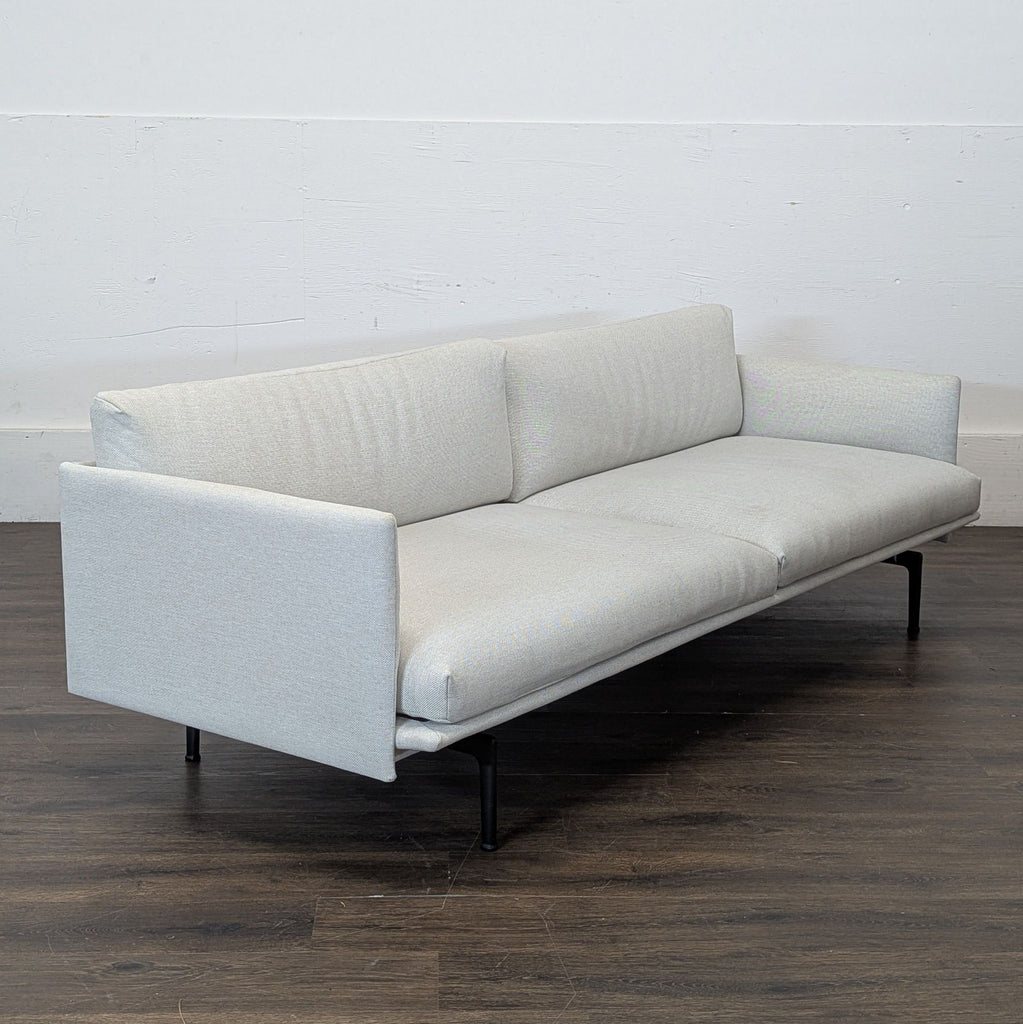 3. Outline loveseat by DWR in gray fabric, showcasing a Scandinavian-inspired modern silhouette.