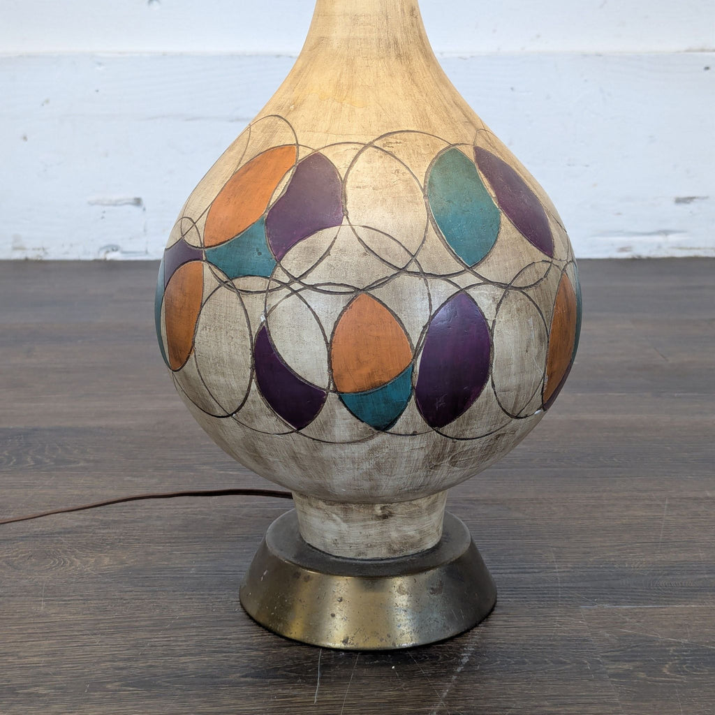 Stylish lighting: Geometric-patterned gourd base table lamp with elegant cream and gold-trimmed shade.