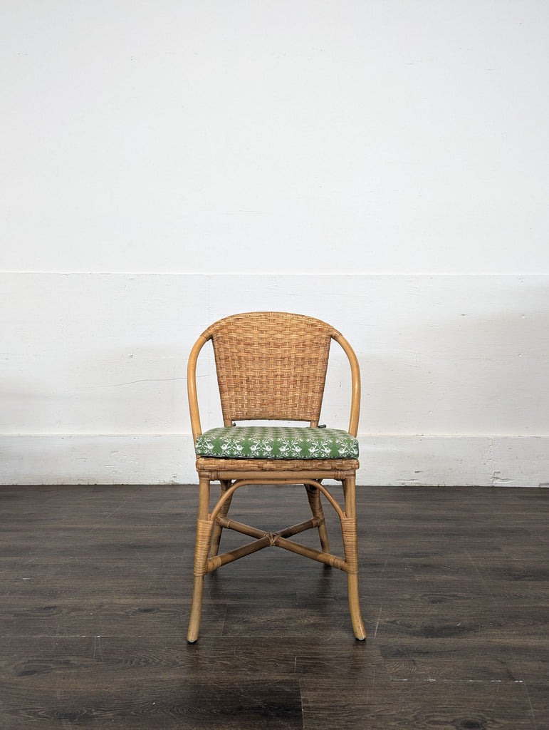 Natural rattan dining chair with MDF seat, cushion, and vinyl-sealed finish from Pottery Barn.