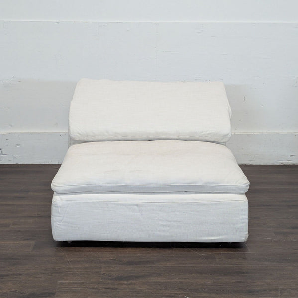 1. Restoration Hardware sectional armless chair in soft white fabric, shown from the front on a wood floor.