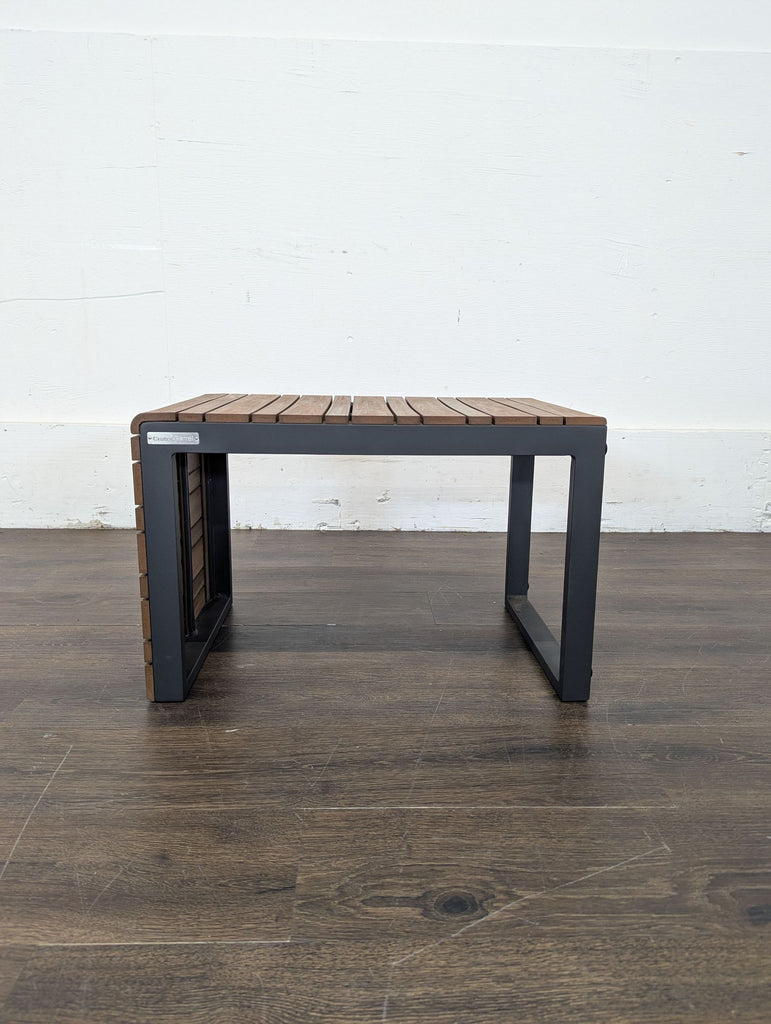 Crate and Barrel modern side table with slatted wood top and black metal frame, ideal for small spaces.