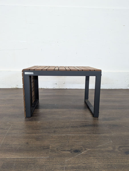 Crate and Barrel side table with a modern slatted wood top and black metal frame; compact and durable design.  
