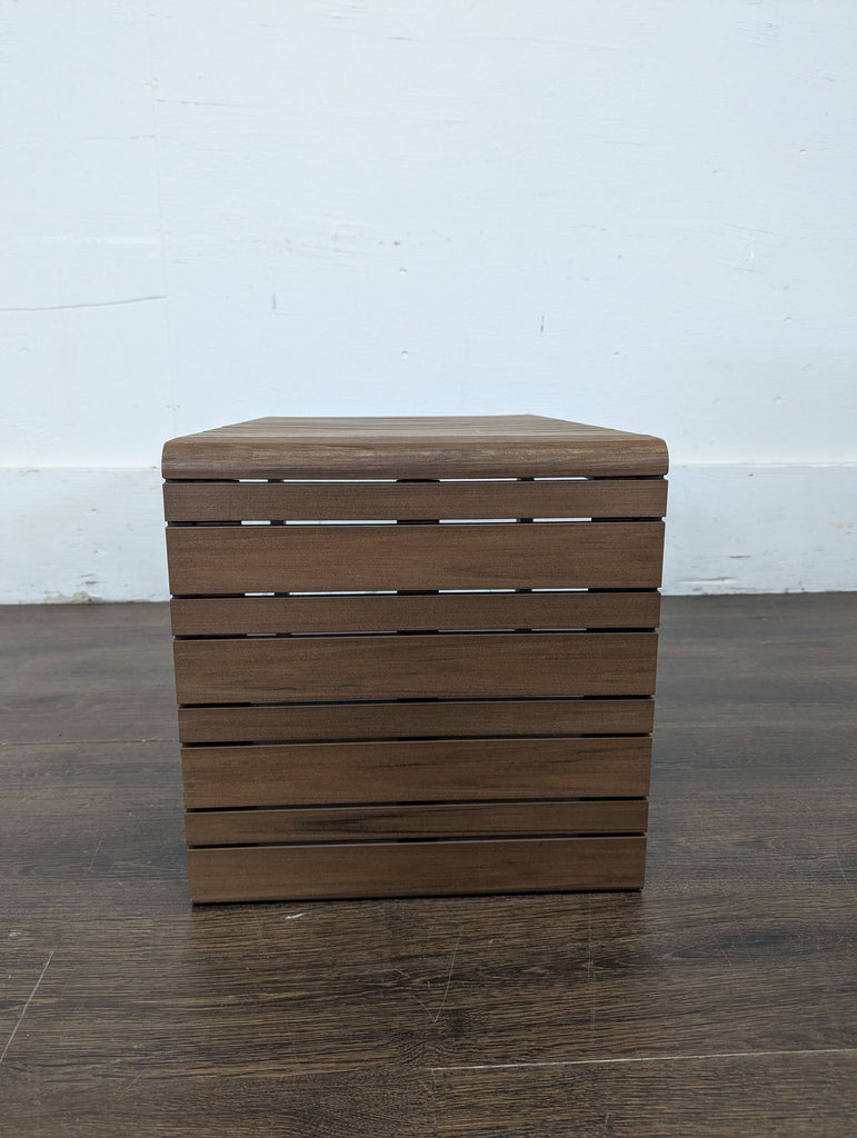 Compact modern end table by Crate and Barrel, showcasing a wood slat top and strong black metal construction.