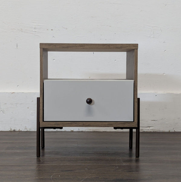 1. Modern end table with a wood frame, open shelf, and single drawer featuring a round knob, on dark legs.