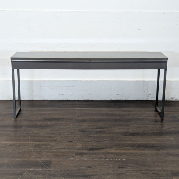 1. Slim, modern Ikea desk with two drawers and open rectangular metal legs, shown against a white wall.