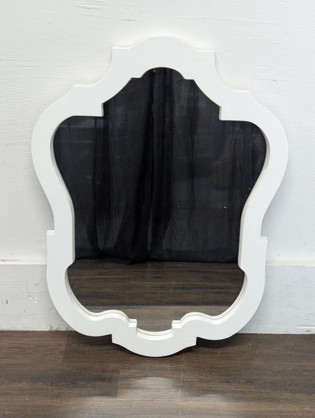 1. Decorative mirror with a thick, ornate white frame, shown resting against a wall on a wood floor.