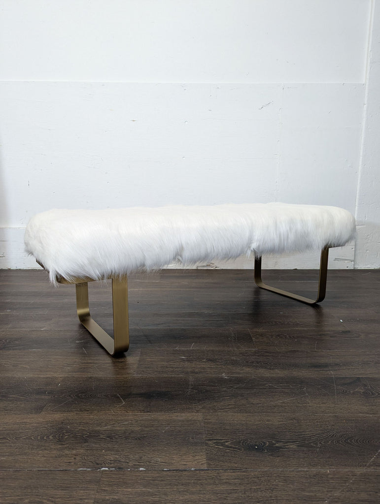 Restoration Hardware faux fur bench featuring sleek gilt metal sled legs, perfect for modern interiors.  
