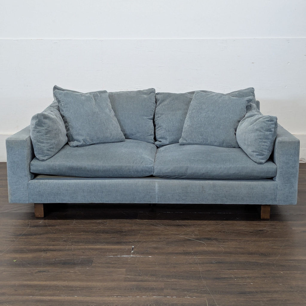 1. Modern 3-seat West Elm sofa with clean lines and plush cushions in a minimalist living room.