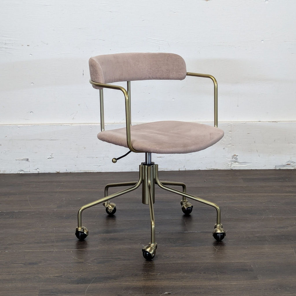 2. Contemporary West Elm lounge chair featuring angled arms and a soft, neutral-toned cushion.