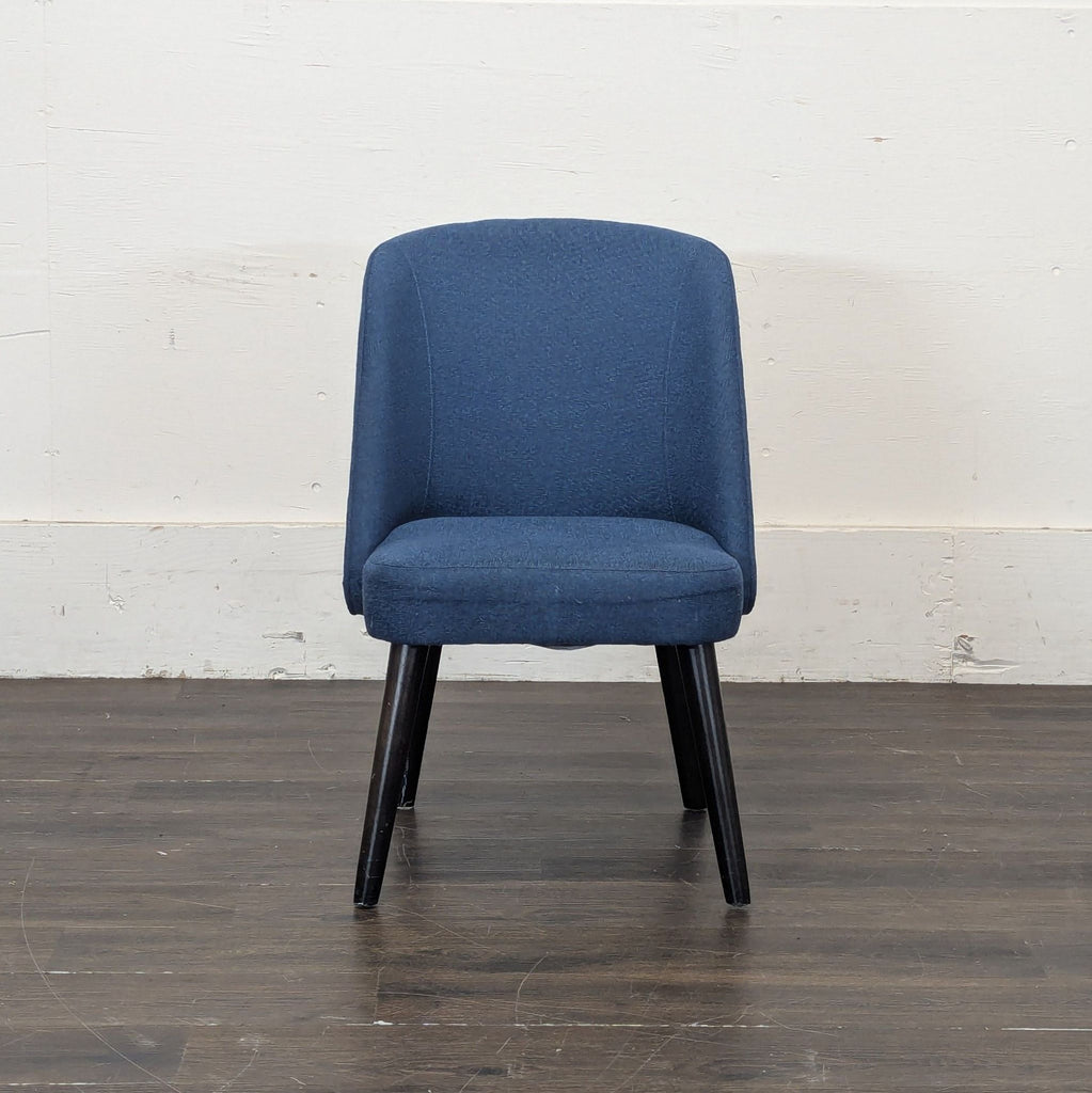1. Modern Room and Board dining chair with sleek wooden frame and cushioned seat, perfect for dining rooms.
