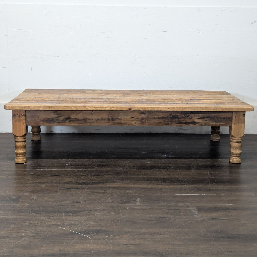 Large vintage wooden coffee table with a worn patina, suitable for spacious living areas or conversion use.  
