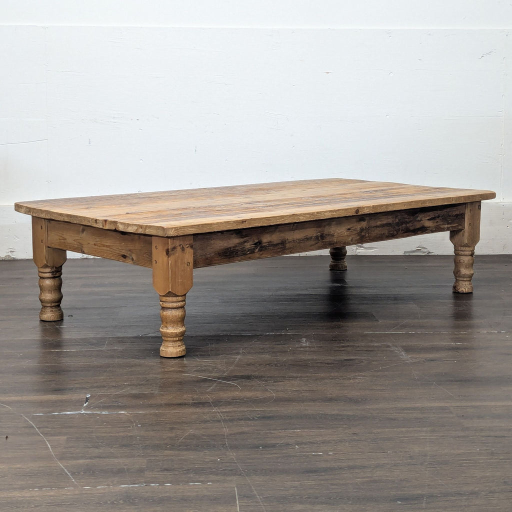 Sturdy, low antique table made of pine; convertible to a dining table, no visible brand markings.