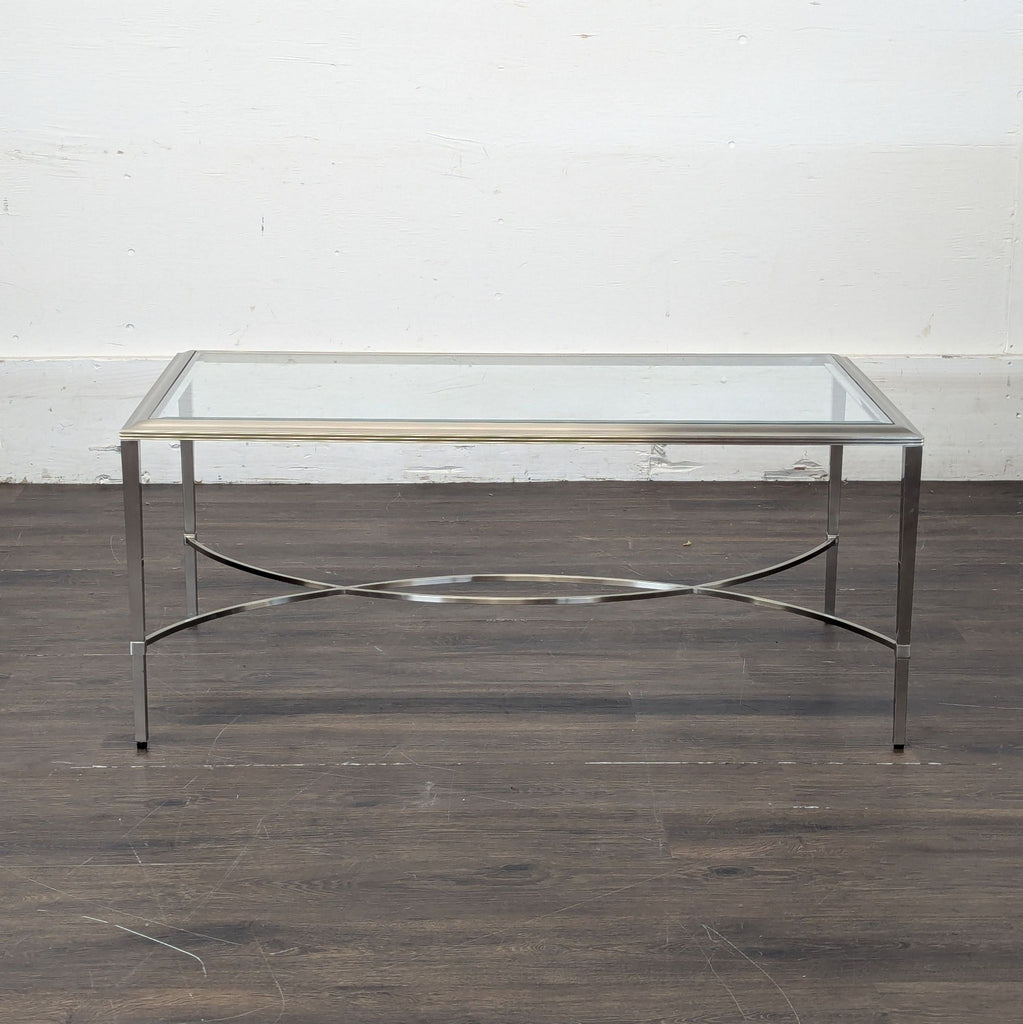 1. Rectangular Ethan Allen coffee table with a glass top and chrome frame, shown against a plain wall.