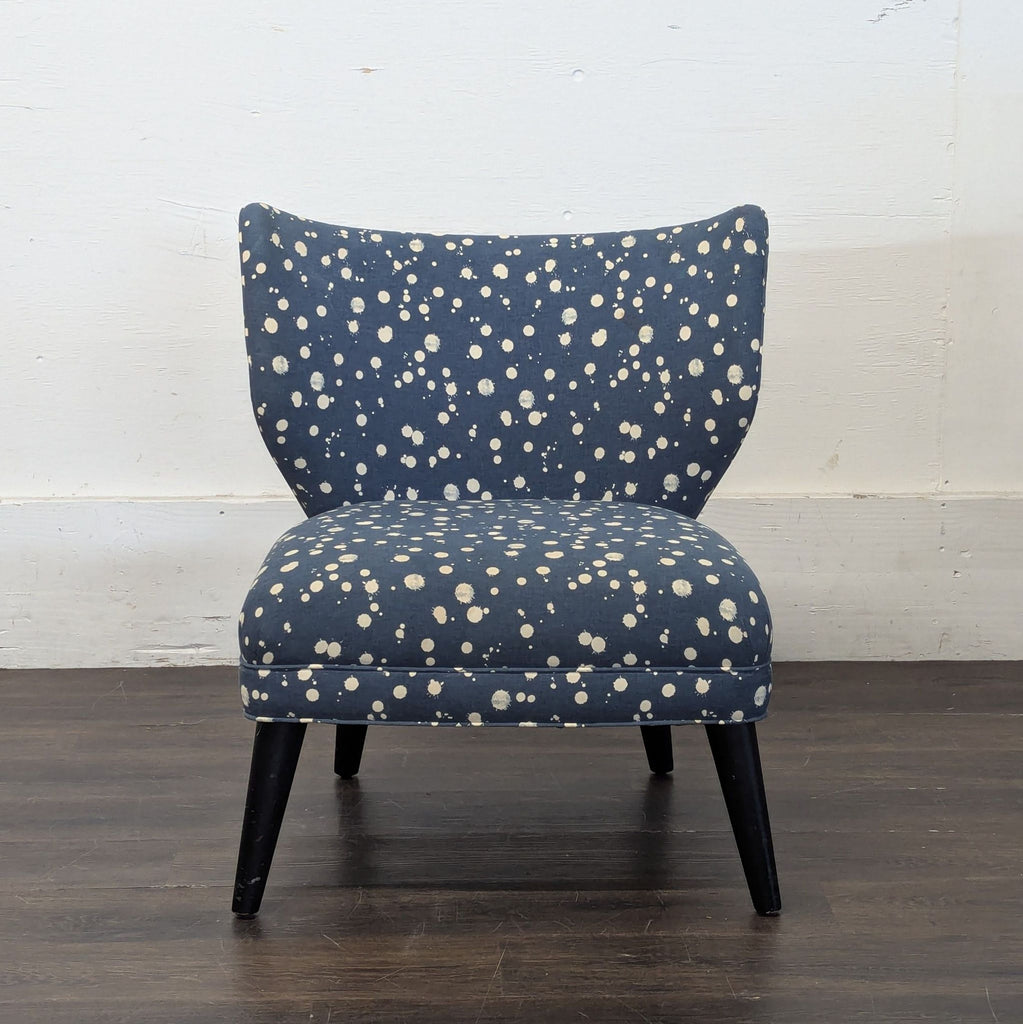 Navy blue lounge chair with cream polka dot pattern, armless design, and dark wood legs, by West Elm + Kate Spade.  