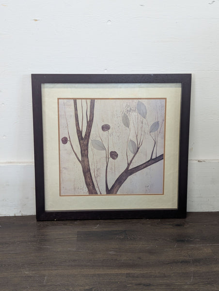 1. Framed artwork featuring a minimalist tree branch with leaves, set against a textured neutral background.