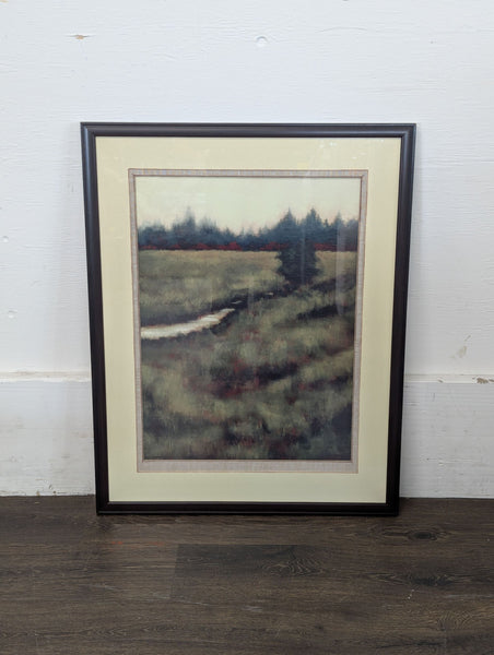 1. Framed painting of a misty landscape with grassy fields, a winding path, and distant evergreens.