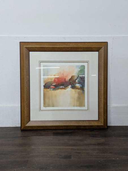 1. Framed abstract watercolor painting with soft earthy tones and hints of red, green, and brown.  