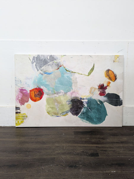 1. Abstract painting featuring colorful organic shapes and brushstrokes on a white background, resting against a wall.  