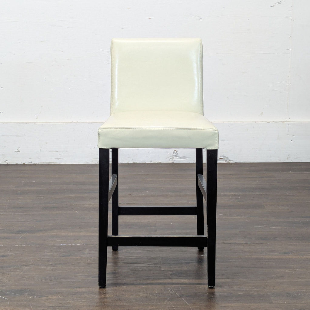 Two sleek bar stools with high backs, suitable for a kitchen island or home bar setting.  