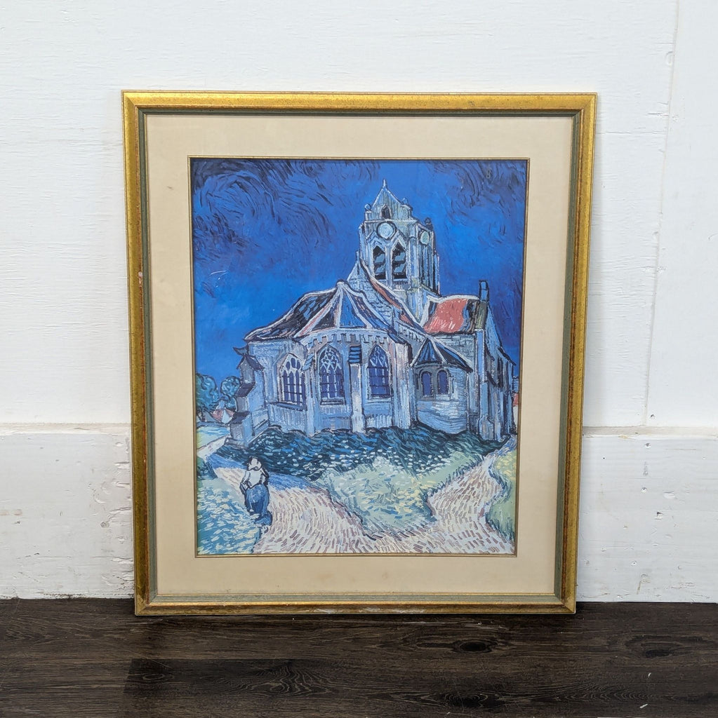 3. Print of a church with bold blue sky and paths, set in a gold frame, influenced by Van Gogh’s art style.