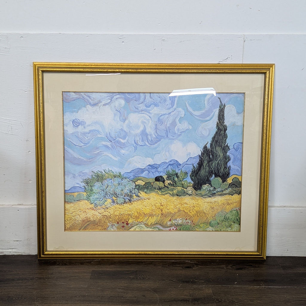 2. Van Gogh-style landscape print in a gold frame, featuring cypress trees and dramatic clouds.  