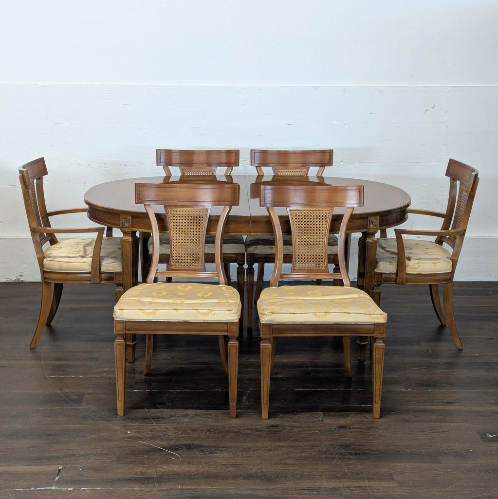 2. Six Thomasville dining chairs with caned backs and a matching oval table, displayed on a wood floor.  