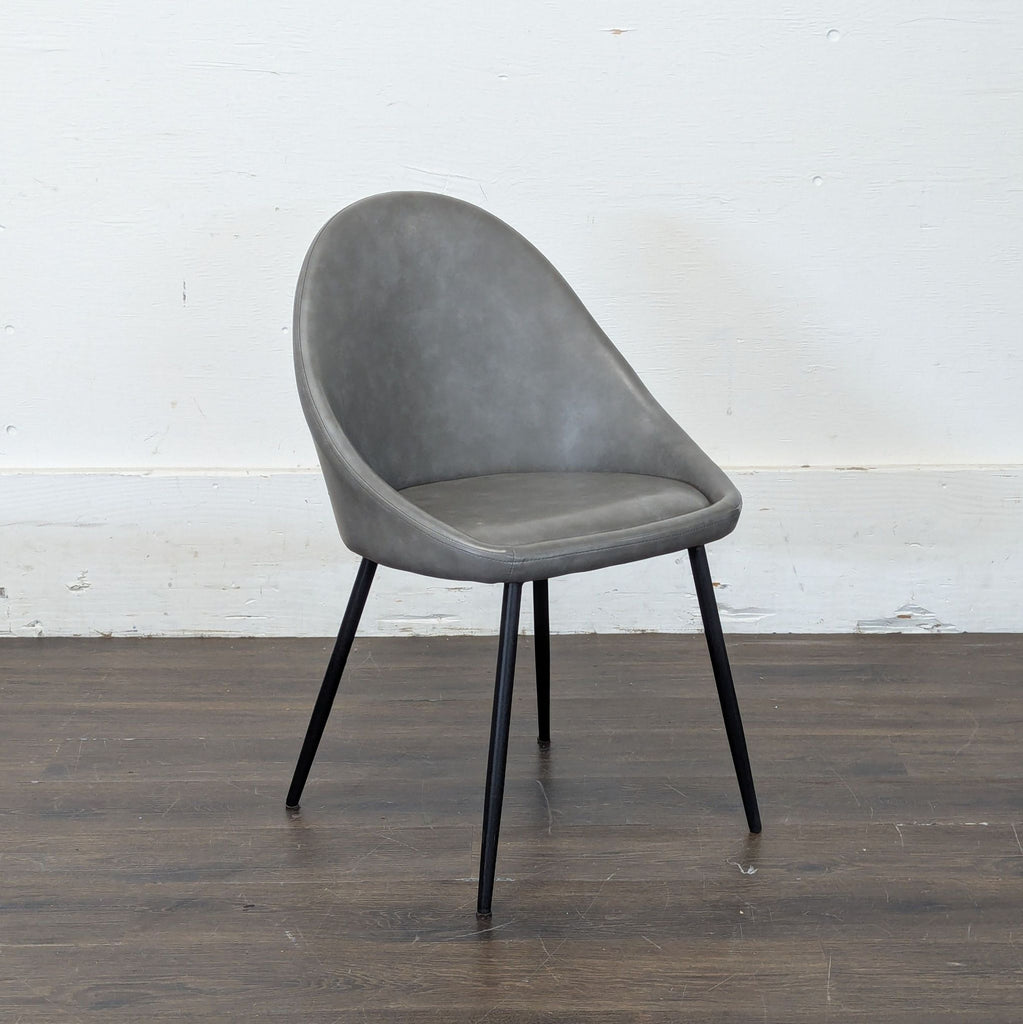 2. Sleek wooden dining chair with a cushioned seat, categorized under dining chairs, brand unknown.