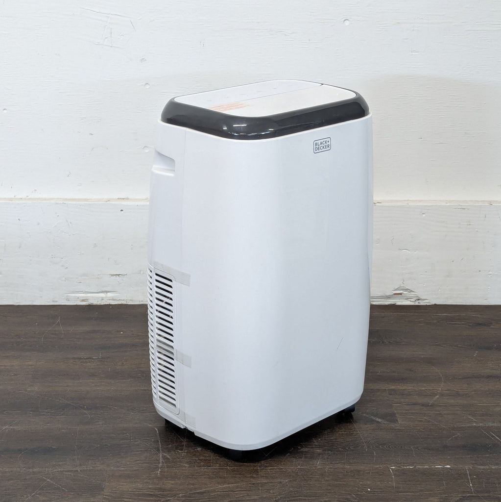 1. A white wall-mounted air conditioning unit installed above a living room window.