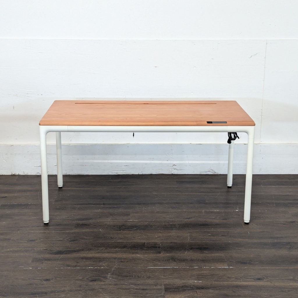 Beflo Tenon Smart Standing Desk featuring a sleek wood surface and sturdy white legs for workspace comfort.